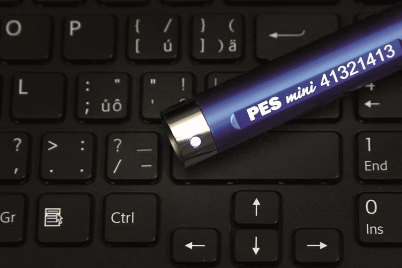 PES Mini reader lying on a laptop keyboard